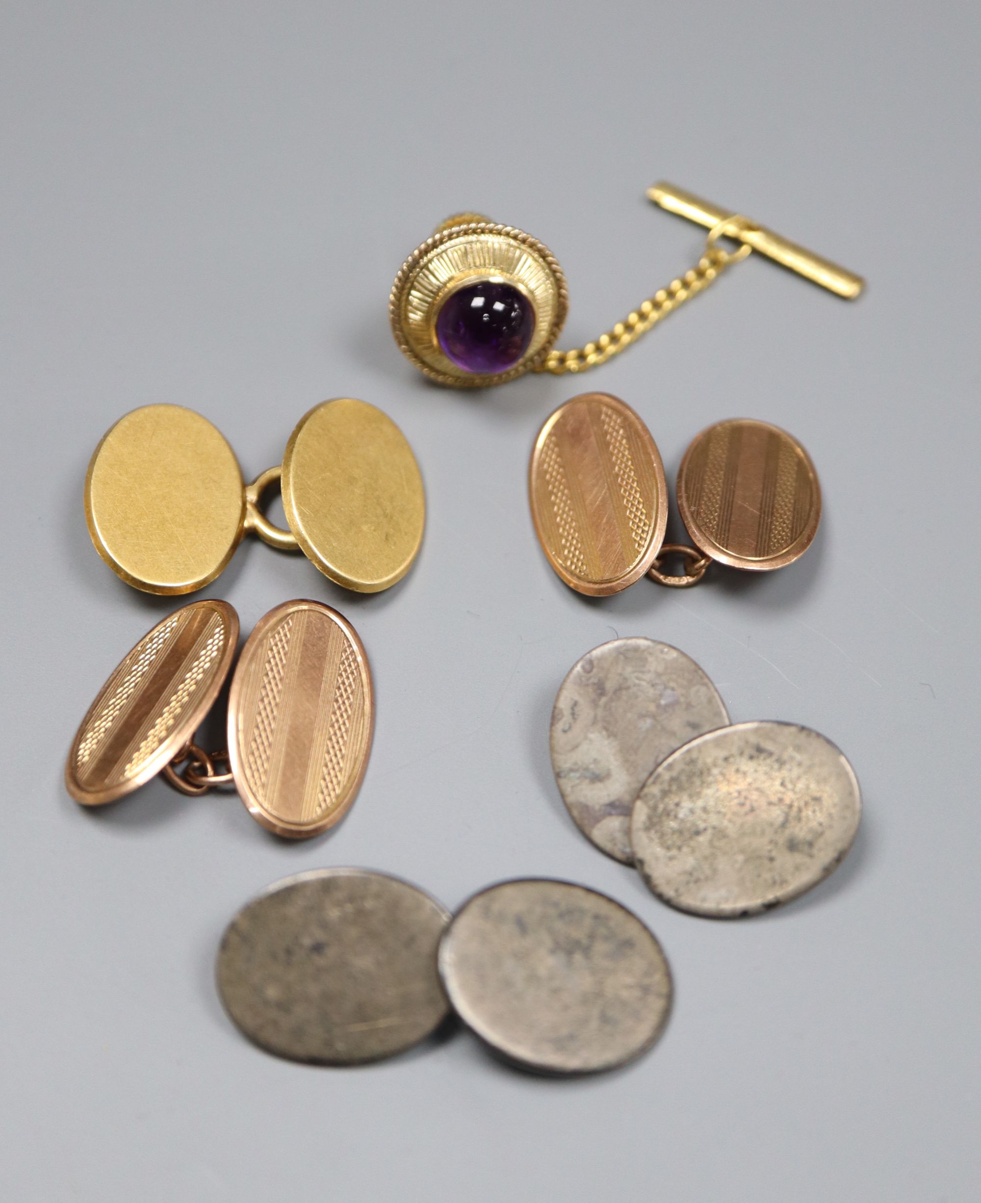 A pair of 9ct gold cufflinks, an 18ct cufflink, a 14k and amethyst dress stud and a pair of white metal cufflinks